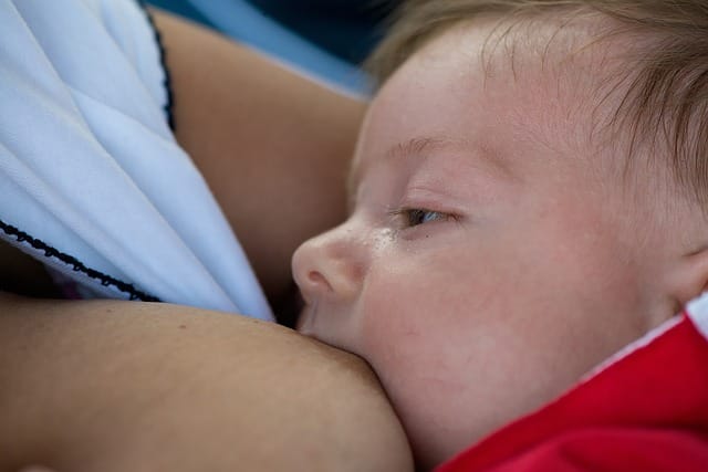 A sleepy toddler being breastfed
